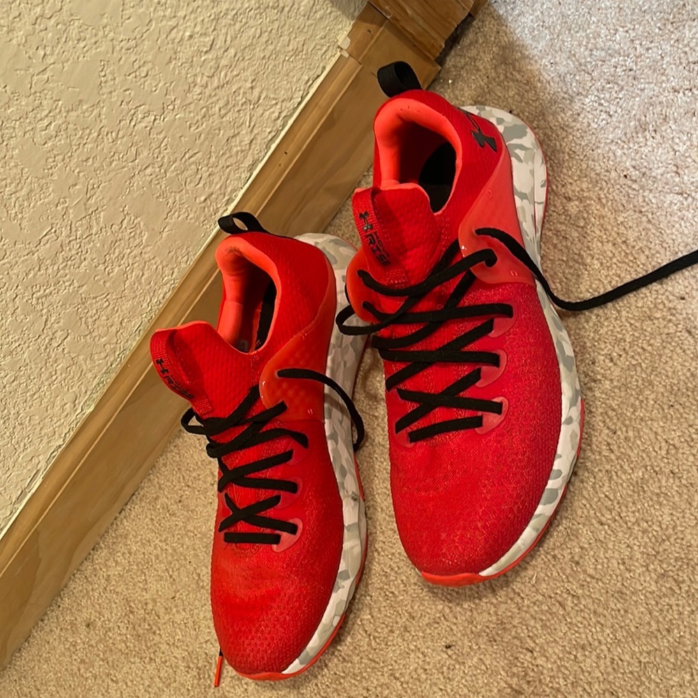 Under Armour red, orange, and white athletic shoes